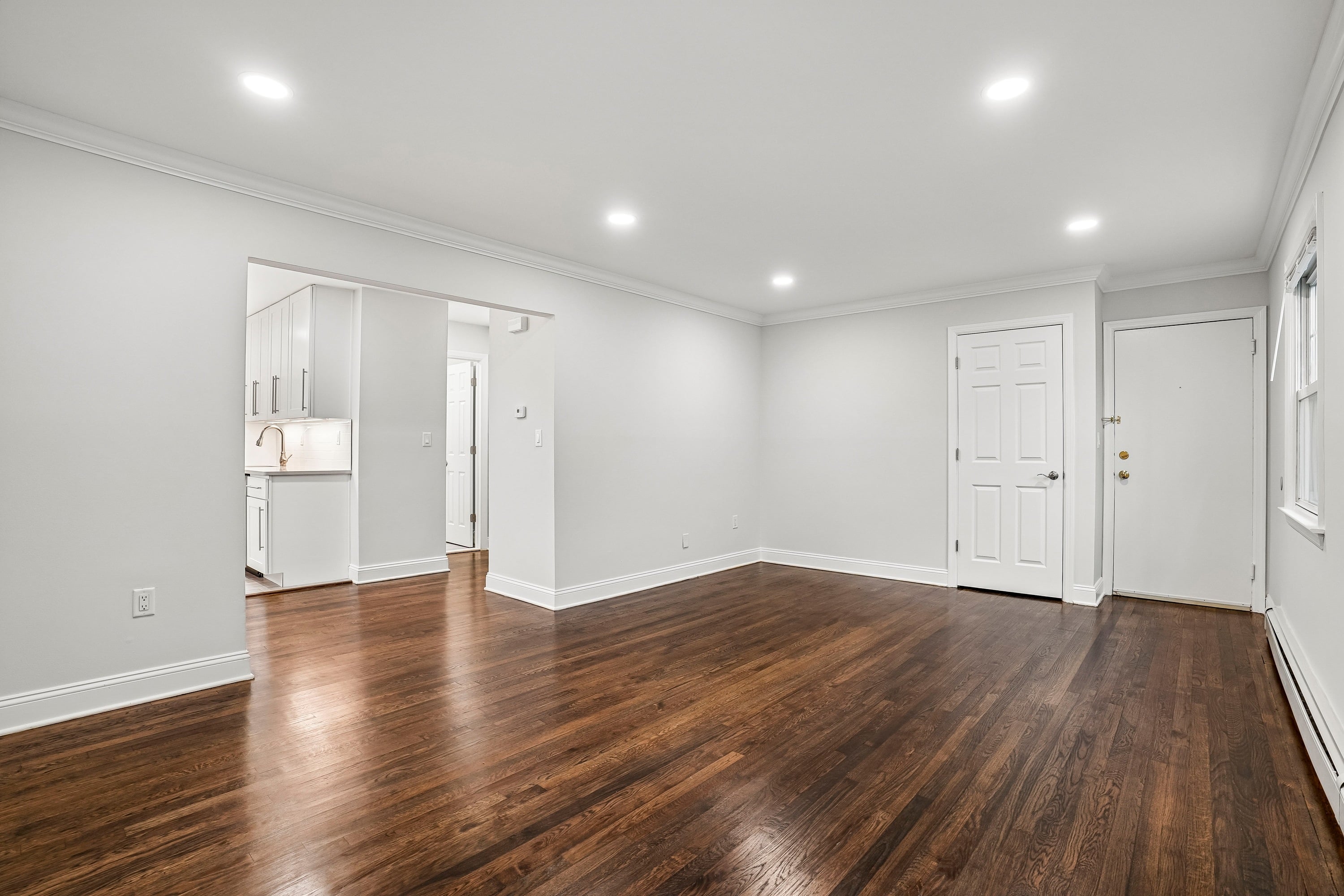 A room with wooden floors and white walls.